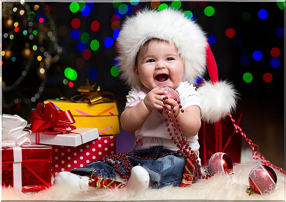 Baby surrounded by all his Christmas presents.