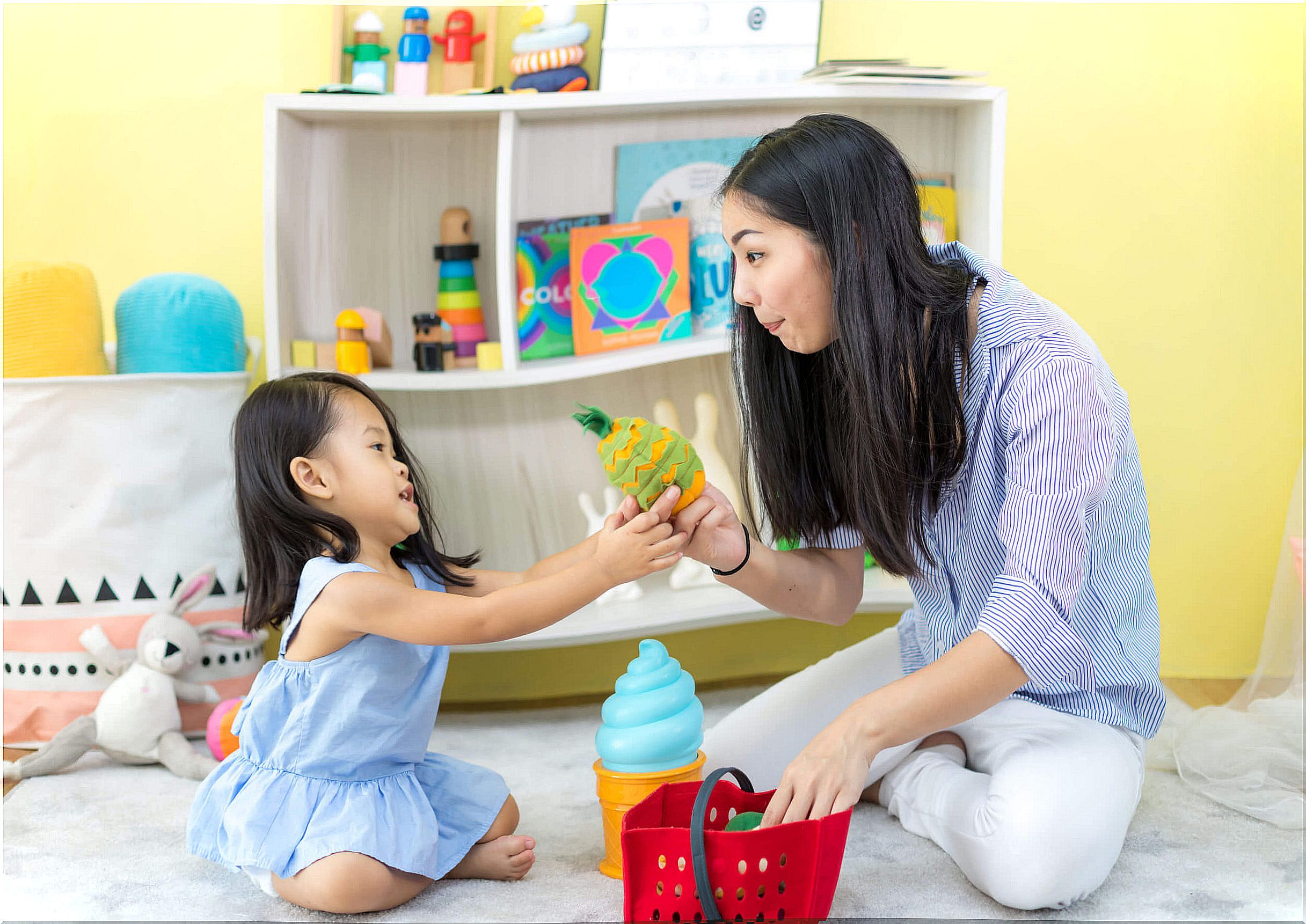 Mother playing with her daughter for her stimulation at home.