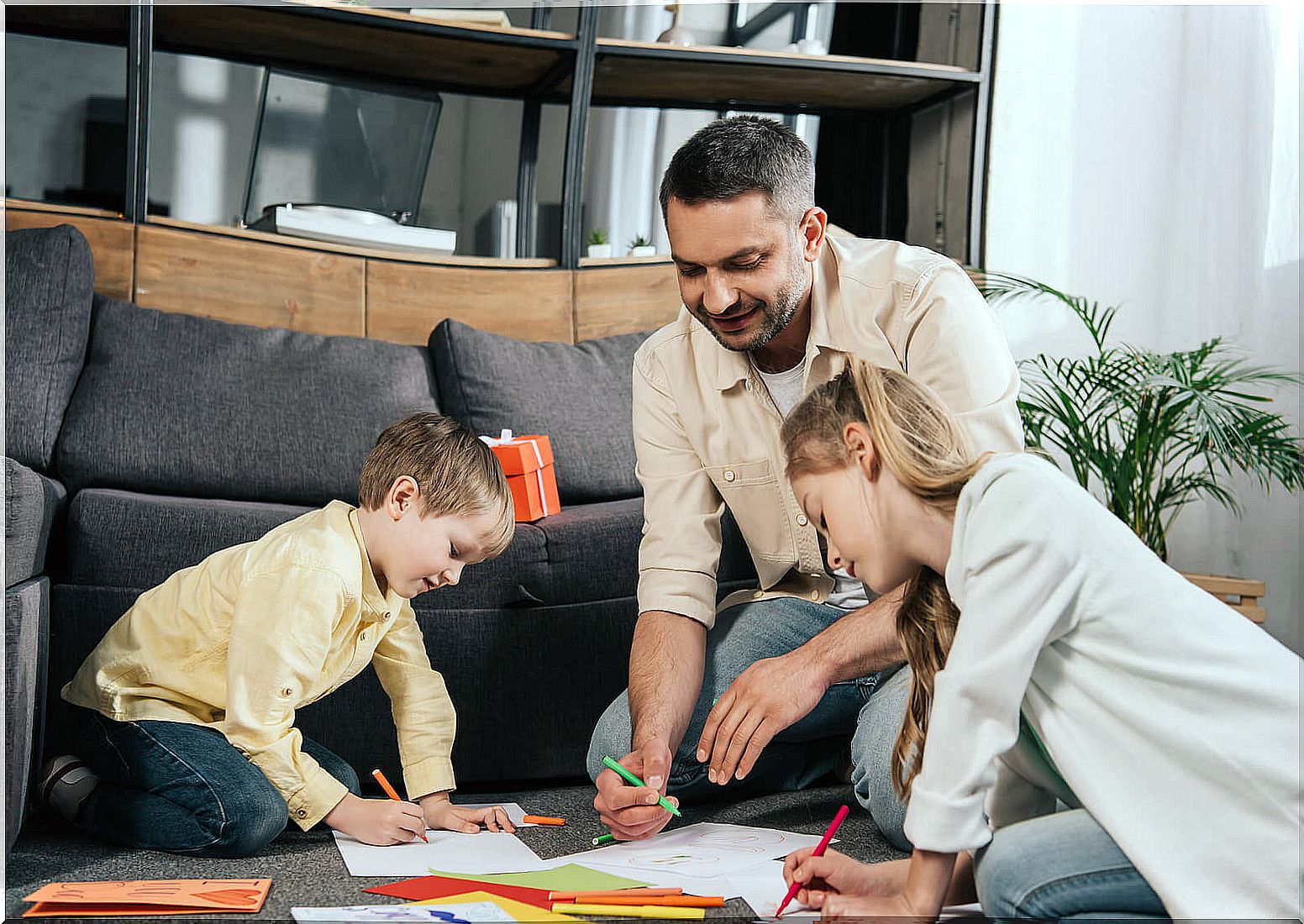 Father painting with his children to help them improve their attention spans.