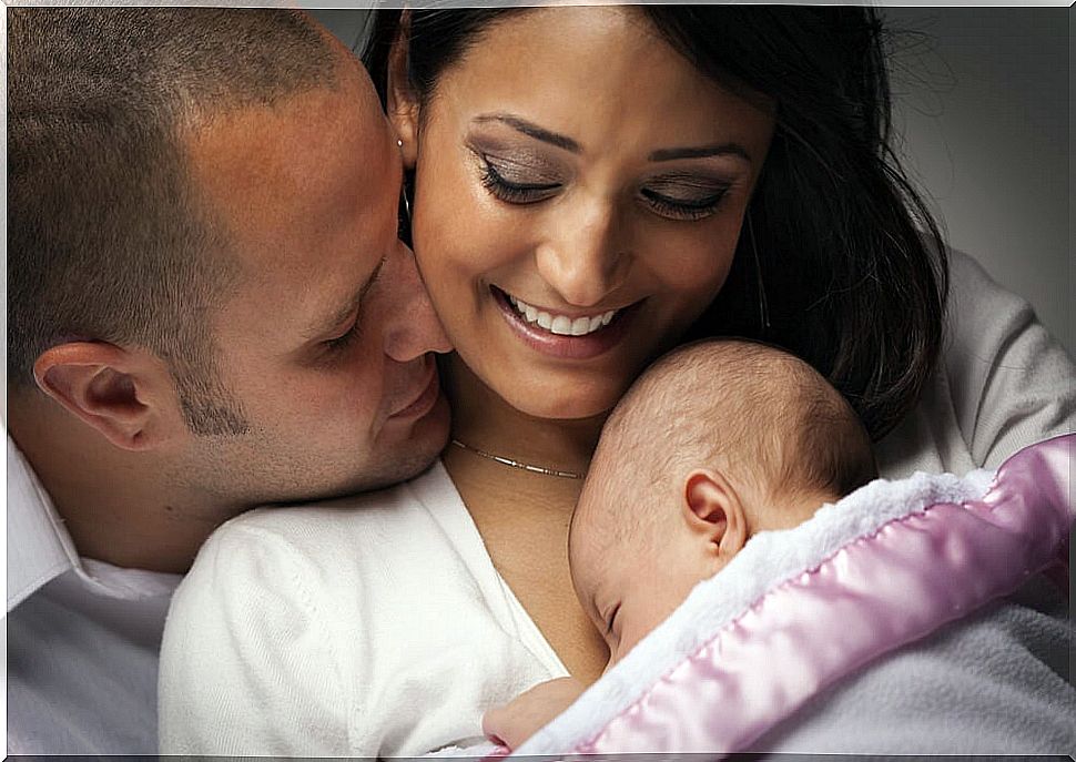 Parents carrying out the pertinent baby care with their newborn.