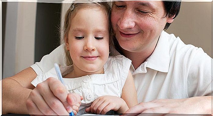 Father helping daughter doing homework.  Parent with child writing