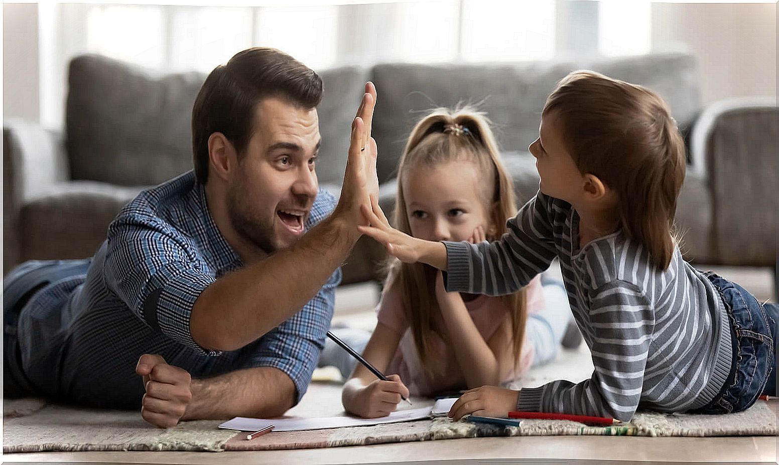 Father high-fiving his son after giving him options when playing games.