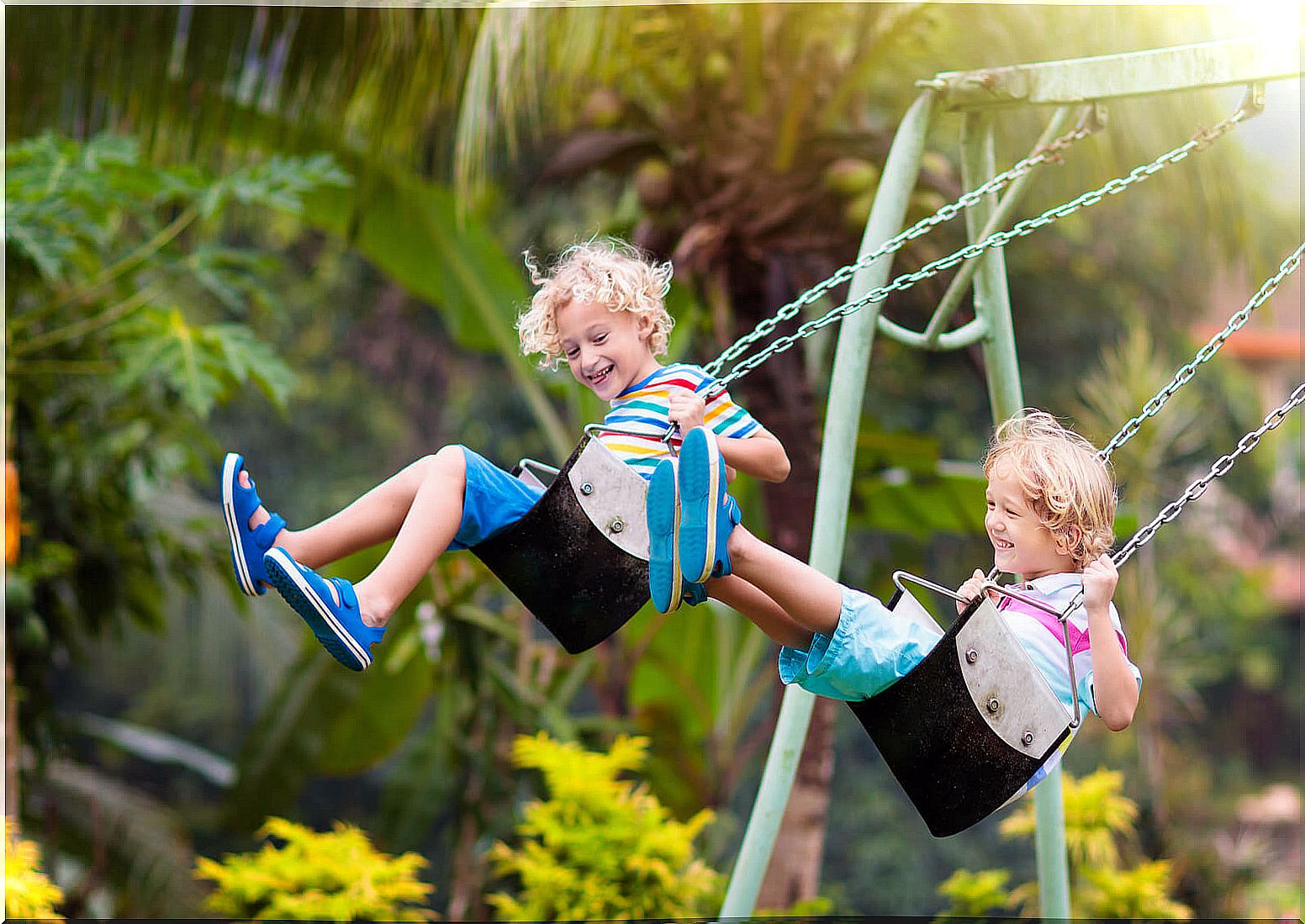 Child playing on the playground swings.