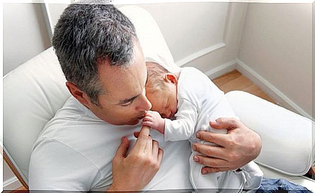 dad with baby in arms