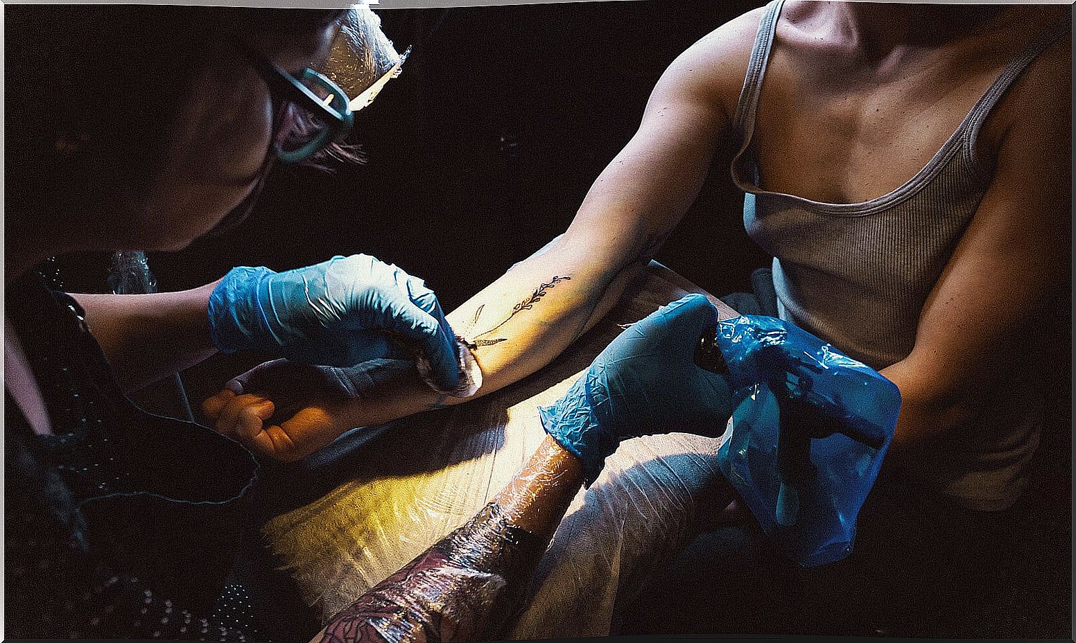 Teenage girl getting a tattoo.