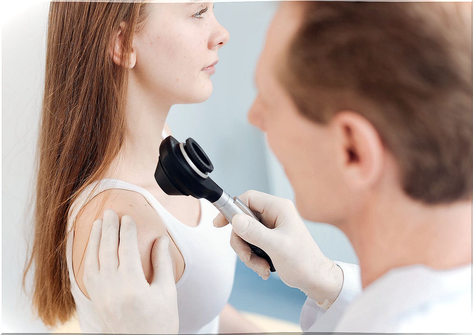 Teen girl at the dermatologist for a melanoma.