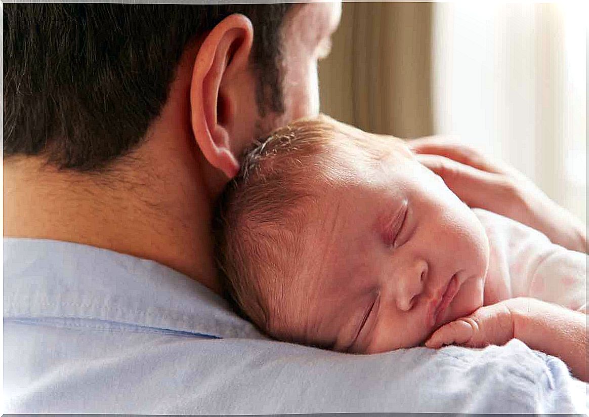 dad with baby in arms