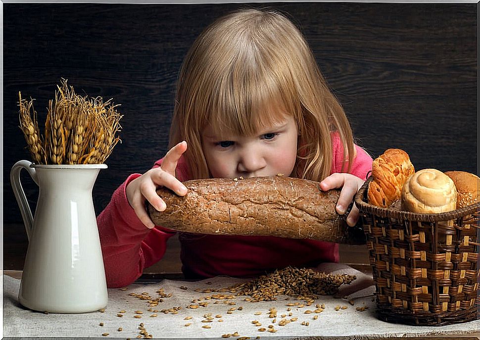 Girl with non-celiac gluten sensitivity with a bread in her hands.