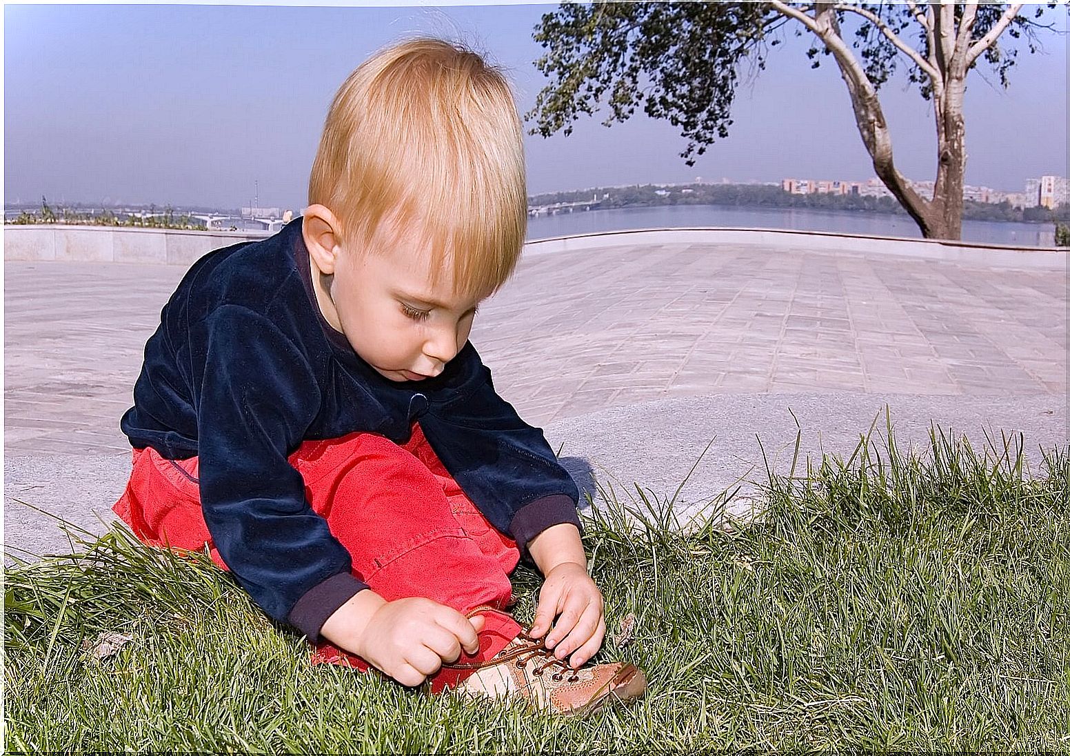 Child learning to tie shoelaces.