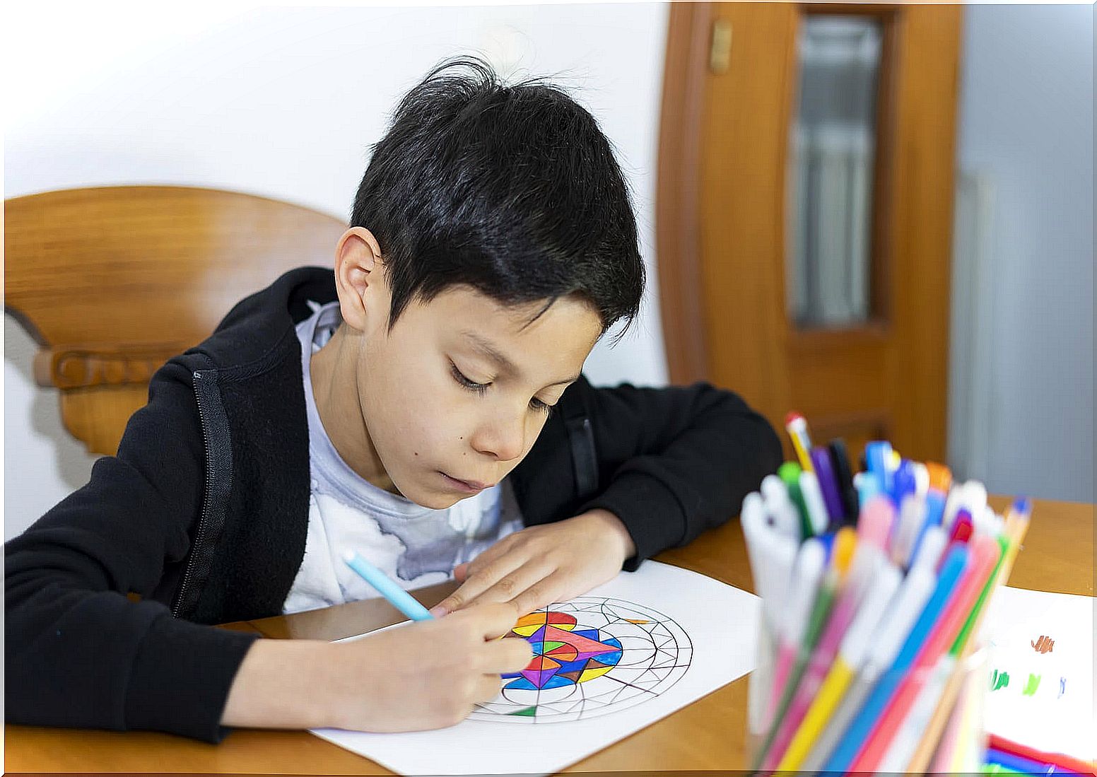 Child painting mandalas, one of the relaxation methods for children by ages.