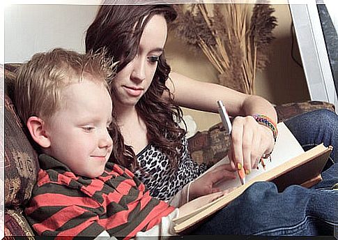 Boy and his caregiver doing homework.