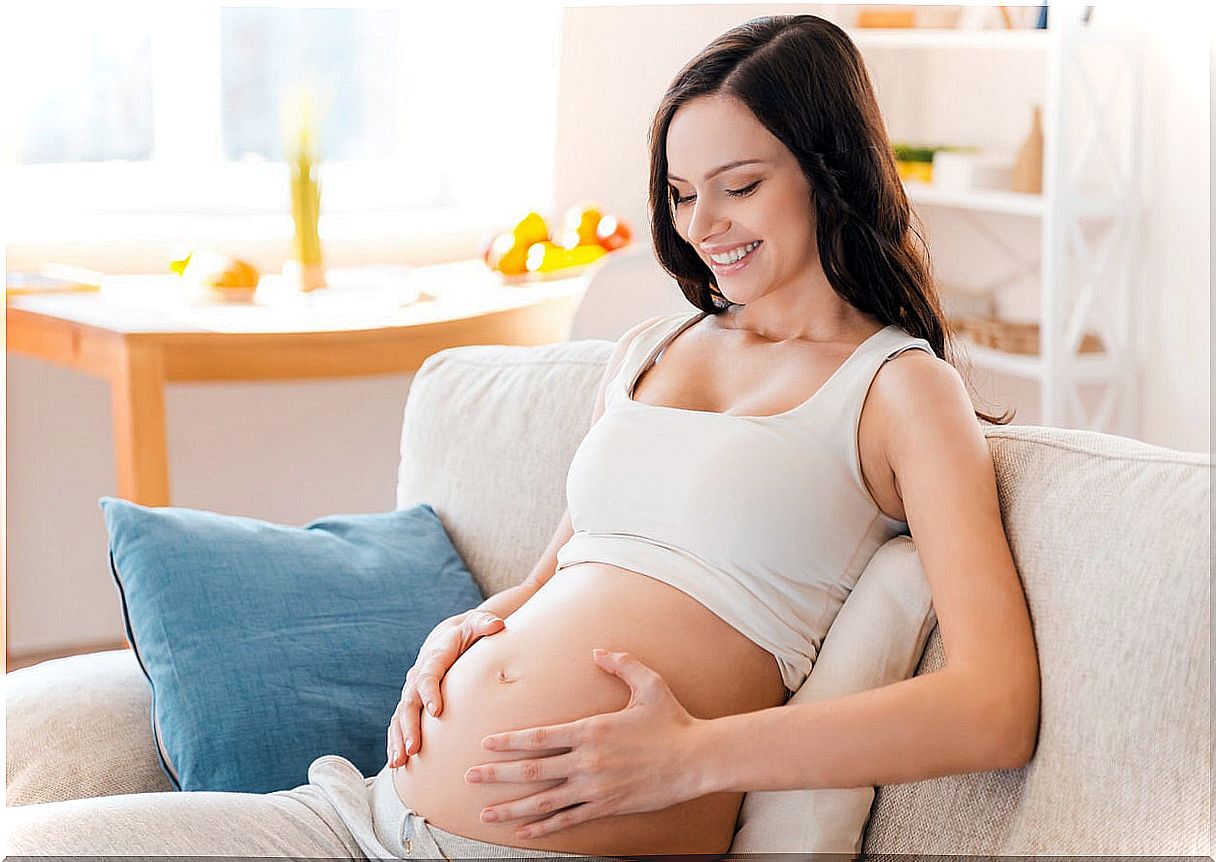 Pregnant woman thinking of natural remedies to whiten teeth during pregnancy.